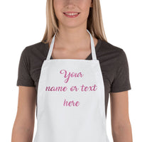female wearing white apron with glitter text