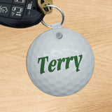 circle shaped key ring with image of golf ball and any name in center