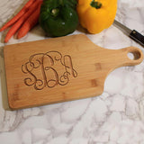 Personalized wood paddle shaped cutting board with up to three monogrammed initials