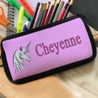 Pencil case pouch with pink background and unicorn head on left, name on right.
