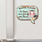 Funny cow speech bubble magnet on refrigerator door, featuring cartoon cow with big grin and text that reads “Heifer Please – The Butter done slid off your Biscuit”