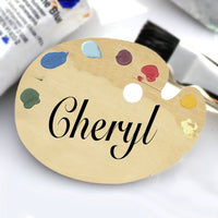 Art Palette Name Badge Wood Background with Paint Dabs on top. Center Text Only