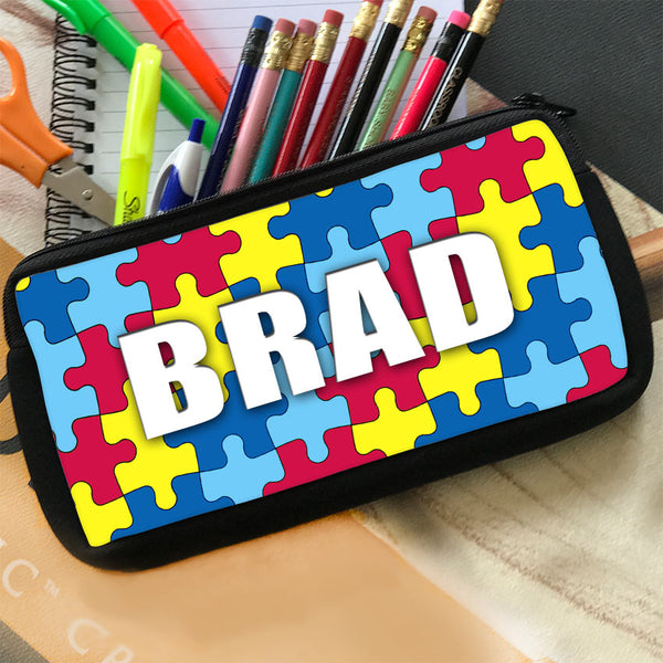 Pencil case pouch with colorful jigsaw puzzle piece design personalized with any name.