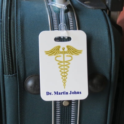 luggage tag shown on luggage with caduceus and doctors name