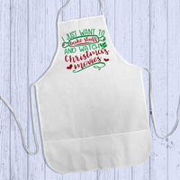 Adult size personalized Baking Apron lying flat on wood.  stating I just want to bake stuff and watch Christmas movies.  Any name personalized below the design