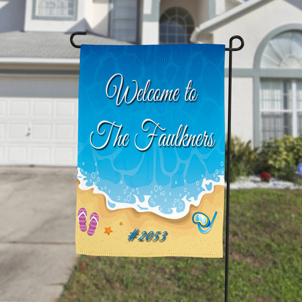 personalized yard flag with illustration of the shore line with snorkel and flip flops with your name and house number