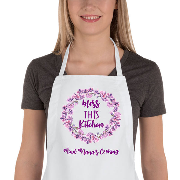 woman wearing bless this kitchen bib apron