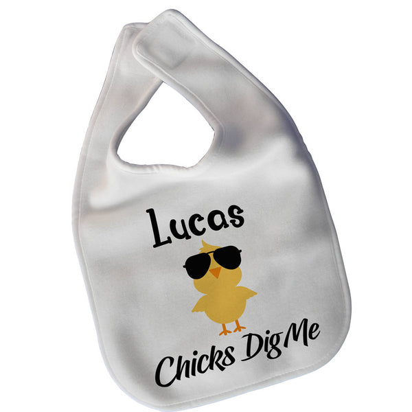 White baby bib with velcro closure with yellow chick a dee and name along with text that says Chicks Dig Me