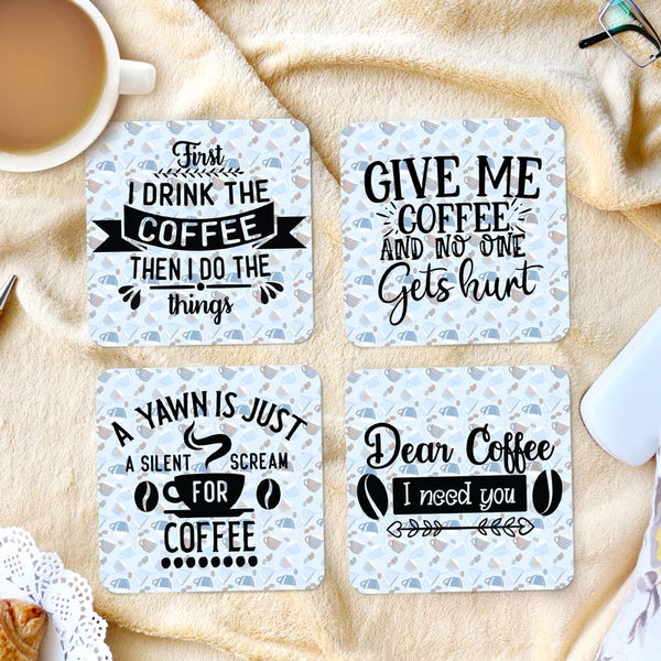 Set of 4 fabric coasters with rubber back. Coffee Cups randomly placed backdrop to four different funny sayings about coffee