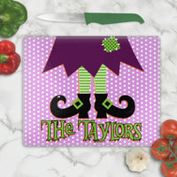 Purple and White Polka Dot Backdrop to Witches feet, legs and skirt in deep purple and fun lime green accents on a tempered glass cutting board with your personalized name or custom text