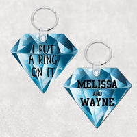 Diamond Shaped Key Ring with Blue Diamond Background 2 sided print one with names the other with I Put A Ring On It in black sports font