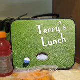 Handle Lunch Tote with golf ball on green near hole image also shows snacks