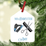 Stylist Tools, comb scissor, blower and iron on a gift tag shaped Christmas Ornament personalized with two lines of text.