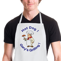 Man with chef hat and frankfurter on a BBQ fork. Top Says Hot Dog - Bottom Gary's Grilling! both top and bottom text can be changed