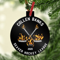 Flaming Hockey Sticks and Puck on a black background with your custom text in white on a reinforced plastic Christmas Ornament