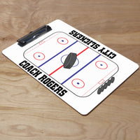 Hockey rink design with pucks and coach's name and team name on a dry erase marker board clip board with flat sports clip.