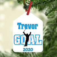 Gift Tag Shaped Ornament with the word GOAL with a hockey rink image within the letters and a silhouette of a player skating with stick in the air after coring. Any name on above and year or jersey number below.