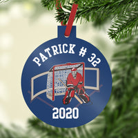 Goalie in front of net on custom hockey ornament. 3 inch plastic ornament with top stem to hold included ribbon. personalized with name, number  and year