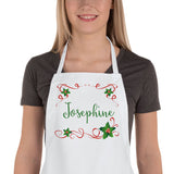 Personalized Apron with holly and ribbon rectangle framing to any name. Apron shown being worn by a woman