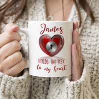Heart with lock hole on a coffee mug and personalized name holds the key to your heart