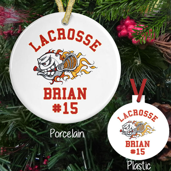 Flaming Lacrosse Ball holding a stick on a porcelain or plastic ornament personalized with any three lines of text.