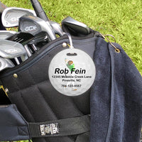 round golf bag tag shown on golf bag
