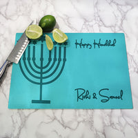 personalized glass cutting boards with light teal background and darker teal menorah, personalized with Hanukkah wishes and any name.
