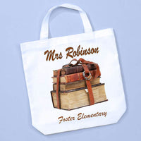 old books in a vintage leather book strap on a custom tote bag personalized