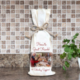 Photo of friends toasting at dinner party on a wine bottle gift bag with custom message