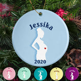 Pregnant woman silhouette with name and year on a personalized porcelain ornament. Image also shows that the ornament can be created in various color choices.