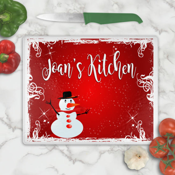 Glass cutting board with Snowman in red blistery background personalized with any name and your choice of font