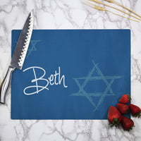 Personalized cutting board with blue background, a lighter blue Star of David and your name or custom text.