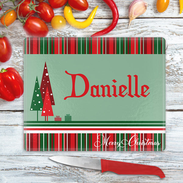Christmas stripes on top and bottom with gift boxes and triangle christmas trees on left center of a solid back along with any personalized name and send line of custom text
