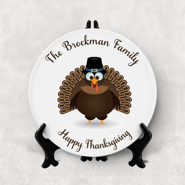 Cute Pilgrim Turkey on a porcelain dinner plate with family name and custom message. Plates are for decorative purposes only